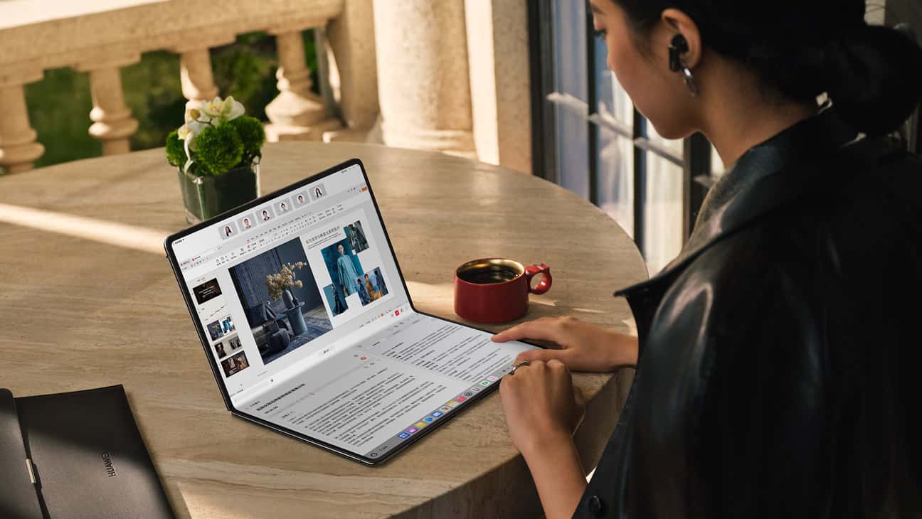 一个女人正在使用桌面上的 HUAWEI MateBook Fold 非凡大师及其 AI 功能制作演示文档