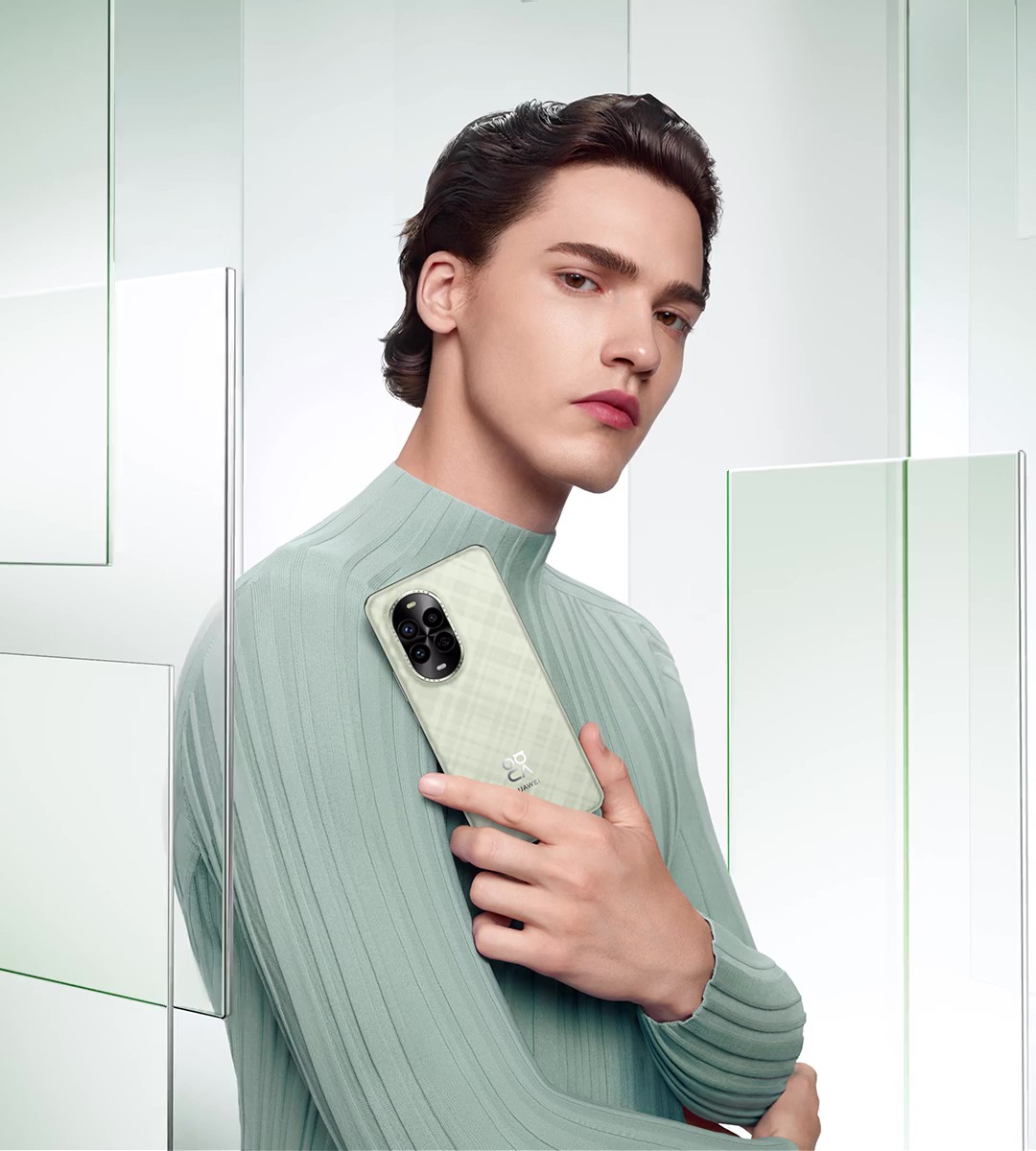 A male model holding a green HUAWEI nova 13 Pro