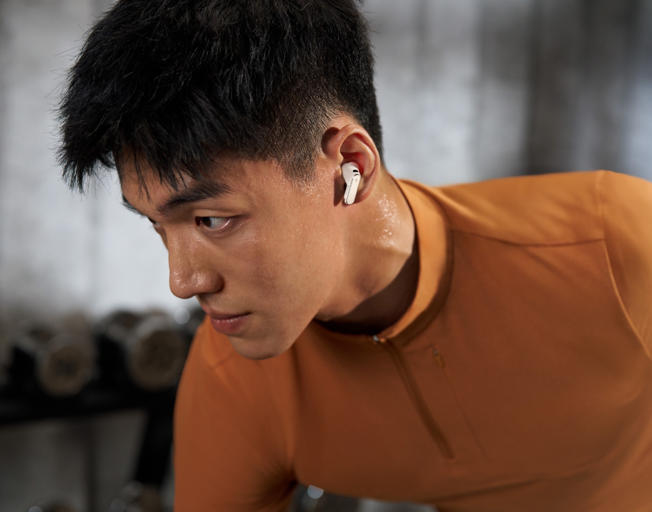 Shows a model wearing HUAWEI FreeBuds Pro 5 while working out, showcasing the water resistance capability.