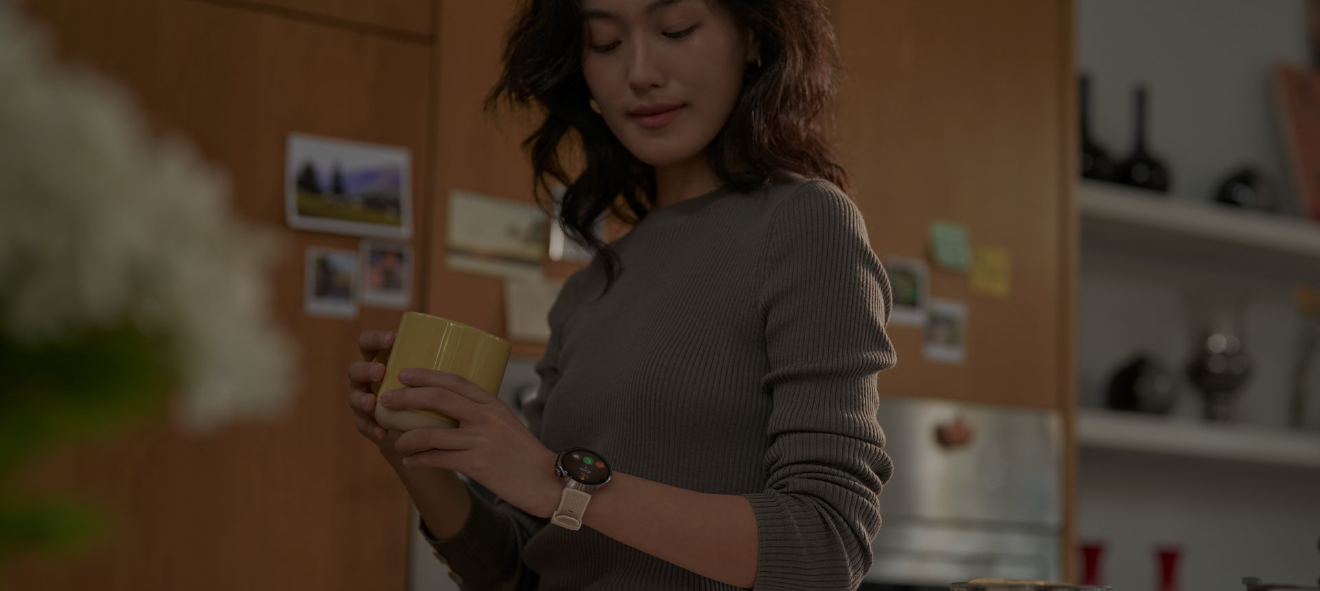 A female user wearing HUAWEI Watch is looking at the data displayed on the watch