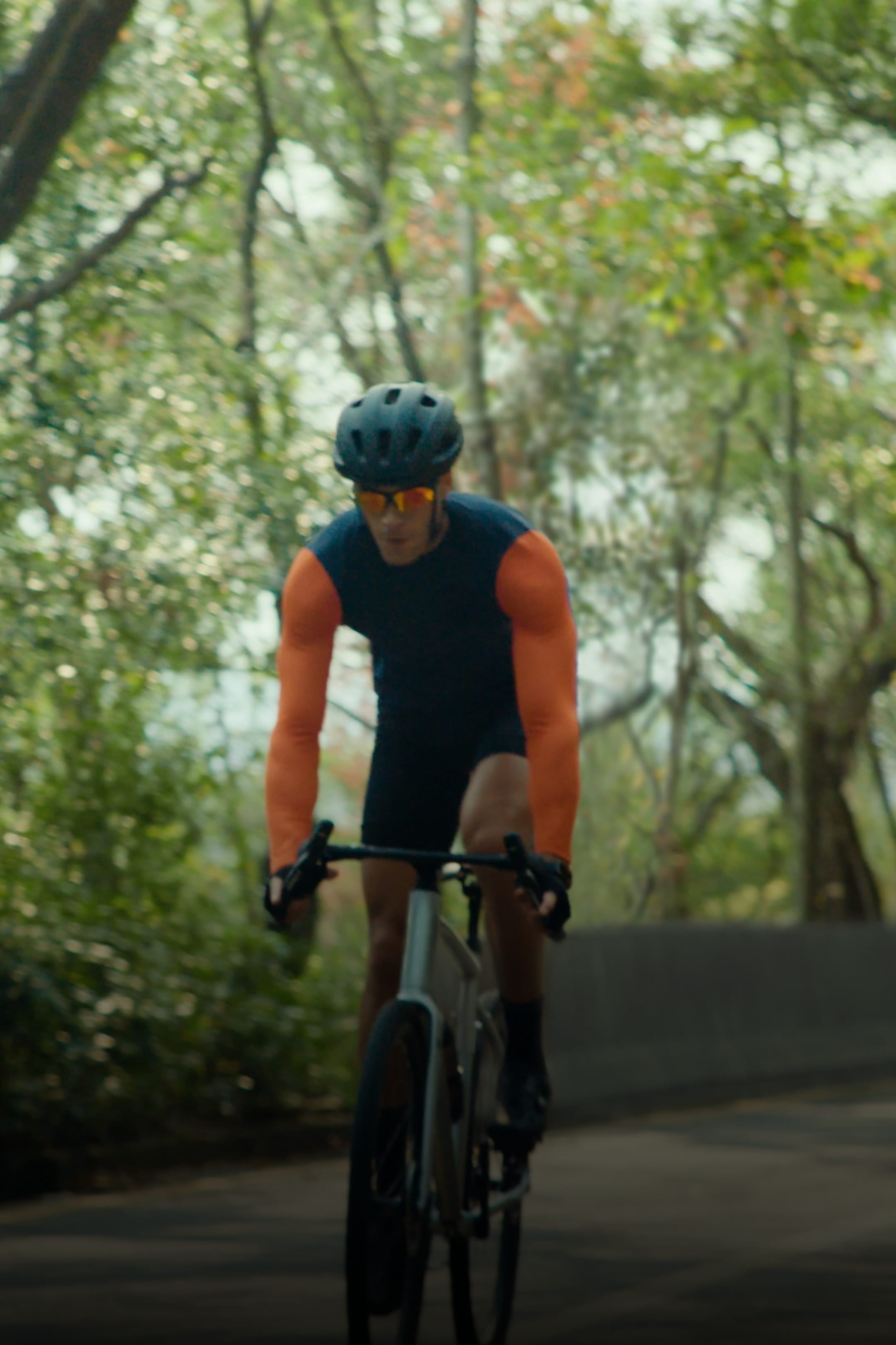 User wearing HUAWEI WATCH FIT 5 Pro while cycling, showing the watch's cycling feature